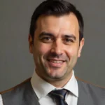 Emad Alashmli walking among giant concrete legs in Henderson, NC—viral creator capturing authentic small-town life.