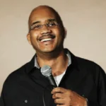 Nicole Simone Henton smiling confidently during a leadership event, representing empowerment and professional success.