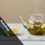 Babeltee modern tea setup with glass teapot and fresh ingredients on wooden table