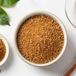 Foenegriek seeds, powder, and tea displayed on white surface showing different preparation forms for health benefits and cooking