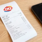MyDQExperience survey receipt with code next to smartphone showing DQ customer feedback form and free Dilly Bar reward