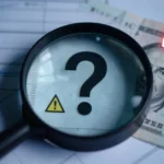 MyGreenBucks Kenneth Jones investigation showing financial documents under magnifying glass with warning signs and question marks