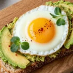 Toastul healthy toast topped with avocado egg and microgreens on wooden board
