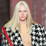 Alex Consani walking runway at fashion show wearing designer outfit transgender model