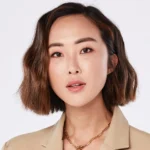 Who is Chriselle Lim - Fashion influencer and entrepreneur at Paris Fashion Week wearing designer outfit, front row seat.
