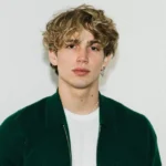 Vinnie Hacker posing for photo showing tattoos and modeling career