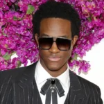 Wisdom Kaye TikTok fashion creator posing in stylish outfit