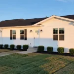 Exterior view of the 14 x 56 021 Champion CHPR-1456 single-wide manufactured home with vinyl siding and shingled roof.