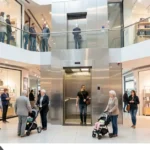 Benefits of installing an elevator at TreeLeftBigShop retail store with customers using it