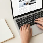 Person reading a curated news feed on a laptop to stay updated online without information overload