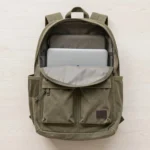 Sungdayer everyday carry daypack with organized pockets and padded straps on a wood surface