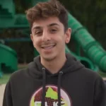 FaZe Rug YouTuber smiling at camera wearing casual clothing