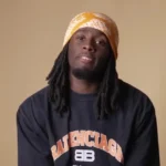 Who is Kai Cenat - Twitch streamer with 19M followers broadcasting from basement bedroom setup with gaming equipment