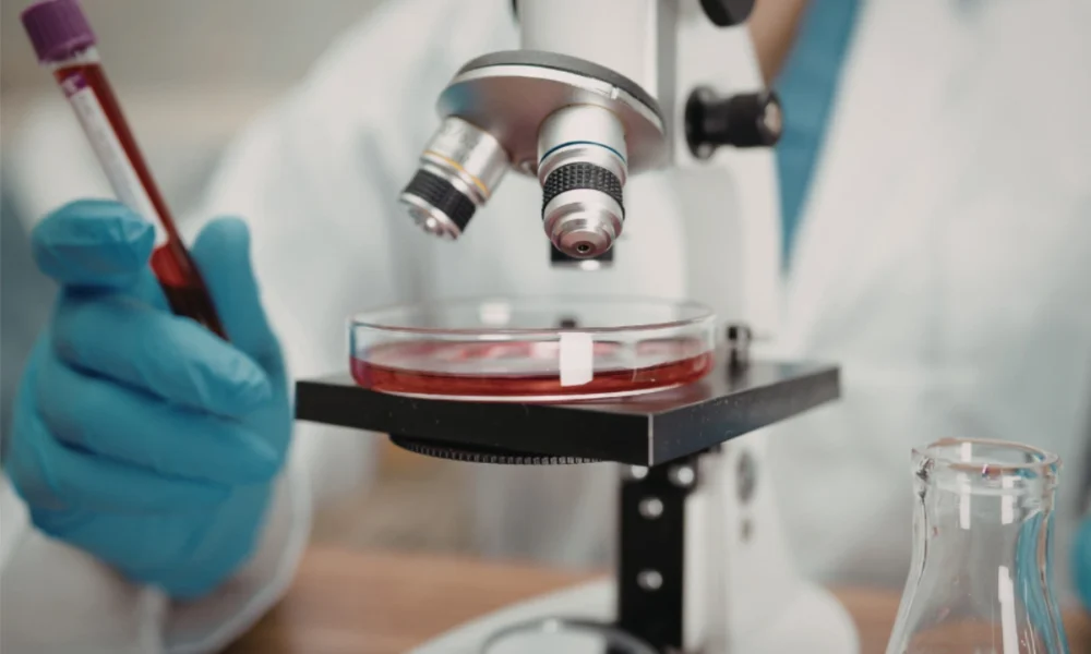 A clinician performing a blood draw at a blood analysis laboratory for preventive healthcare screening