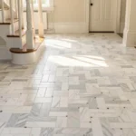 Honed Carrara basket weave marble floor in Chatham NJ entryway with classic colonial trim and wood staircase.