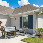 Gutt R Done Seamless gutters being installed on a home in Lafayette with a roll-forming machine on the driveway.