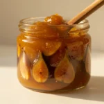 Jar of mustarda with golden-brown preserve and spoon, traditional Croatian mustarda condiment made with mustard seeds