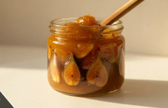 Jar of mustarda with golden-brown preserve and spoon, traditional Croatian mustarda condiment made with mustard seeds