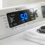 Whirlpool Washer 5D Code showing on front-load washer with HE detergent bottle and clean drain filter nearby.