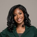 Maxine Owusu emergency medicine doctor and STEM advocate holding a children's book