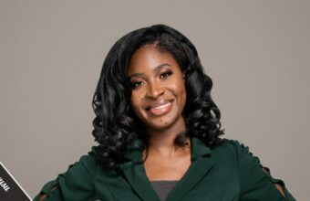 Maxine Owusu emergency medicine doctor and STEM advocate holding a children's book