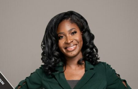 Maxine Owusu emergency medicine doctor and STEM advocate holding a children's book