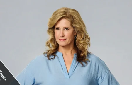 Nancy Travis, mid-50s, smiling in a casual linen blazer on a sunlit Brentwood patio, embodying the quiet confidence behind her $5 million net worth.
